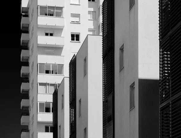 Apartment buildings press together in a rhythmic pattern of windows, balconies, and shutters, Mediterranean architecture rendered as abstract composition in Sète