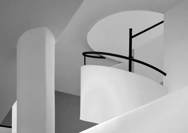 The elegant spiral ramp of Villa Savoye, white curves and black railing drawing a pure modernist form in Le Corbusier's iconic Poissy residence
