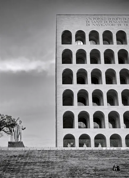 The Palazzo della Civiltà Italiana in Rome, its repeating arches and a solitary statue evoking the metaphysical paintings of Giorgio de Chirico
