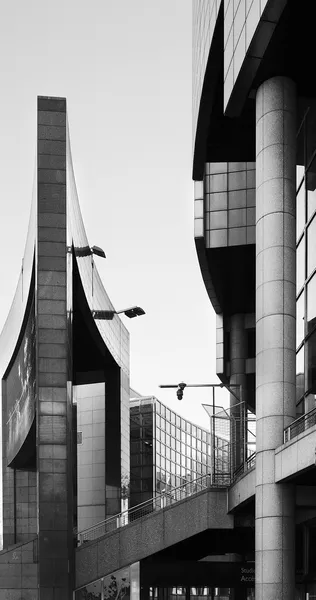 Sweeping curves and angular forms of modern Parisian architecture create a vertical dialogue of stone, glass, and steel in this minimalist black and white composition
