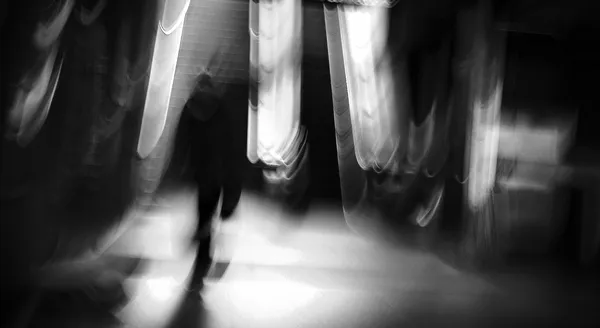 A ghostly figure descends a BART station staircase in San Francisco, motion blur and light streaks dissolving the human form into pure abstraction