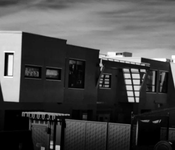 Modern San Francisco townhouses rendered in blurred soft focus, their angular forms and dark facades becoming an abstract composition of urban geometry